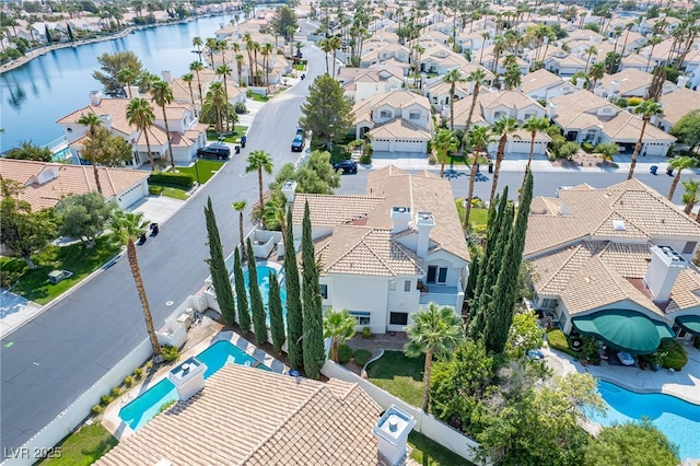 birds eye view of property with a water view and a residential view