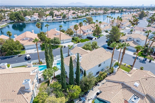 birds eye view of property with a water view and a residential view