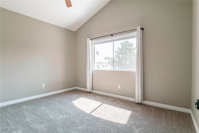 unfurnished room featuring lofted ceiling, carpet, and baseboards