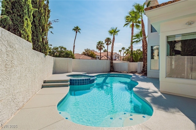 view of pool featuring a pool with connected hot tub, a fenced backyard, and a patio