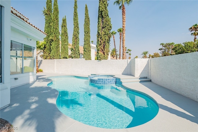 view of swimming pool featuring a patio area, a fenced backyard, and a pool with connected hot tub