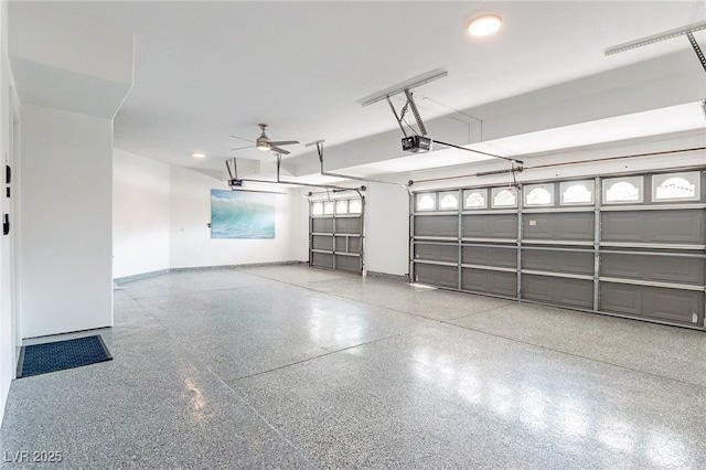 garage with a garage door opener and baseboards