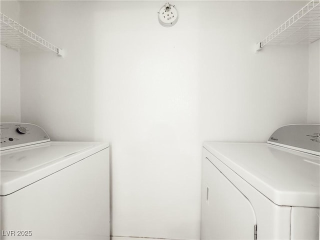 laundry area with laundry area and washing machine and clothes dryer