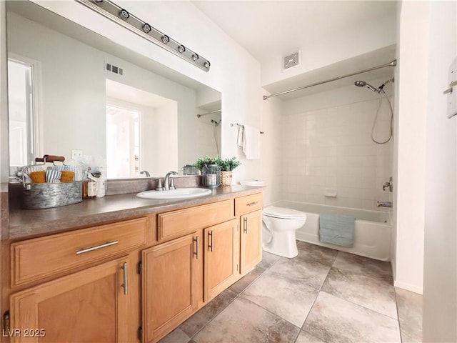 bathroom featuring washtub / shower combination, visible vents, vanity, and toilet