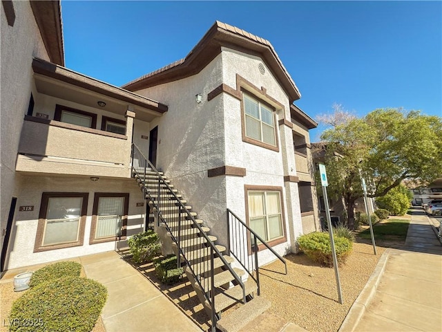 entrance to property featuring stucco siding