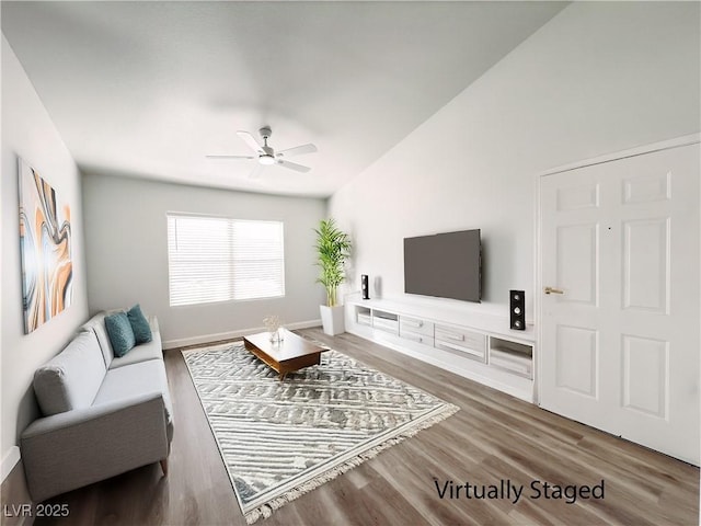 living area featuring a ceiling fan and wood finished floors