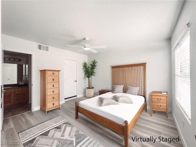 bedroom with visible vents, light wood-style flooring, baseboards, and multiple windows