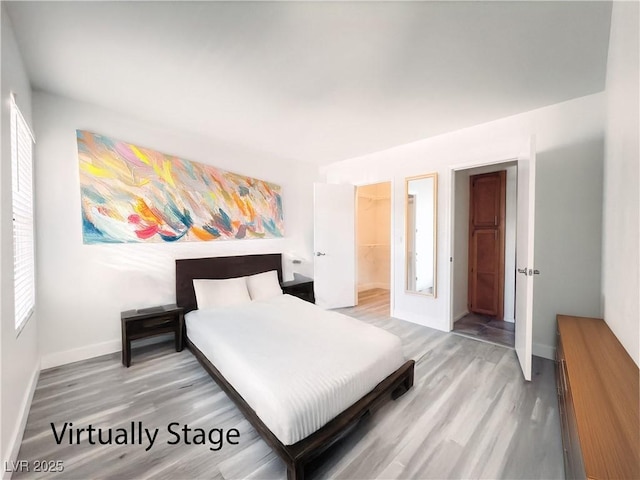 bedroom featuring light wood-style flooring and baseboards