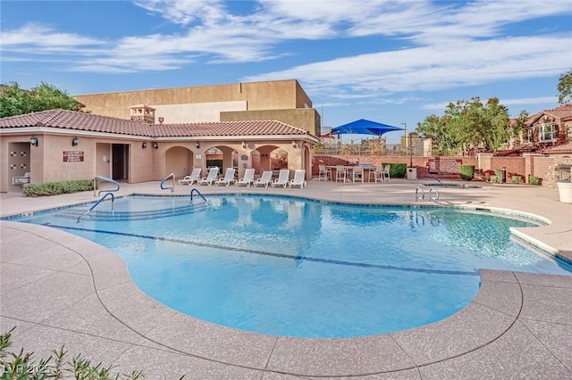 community pool featuring a patio and fence