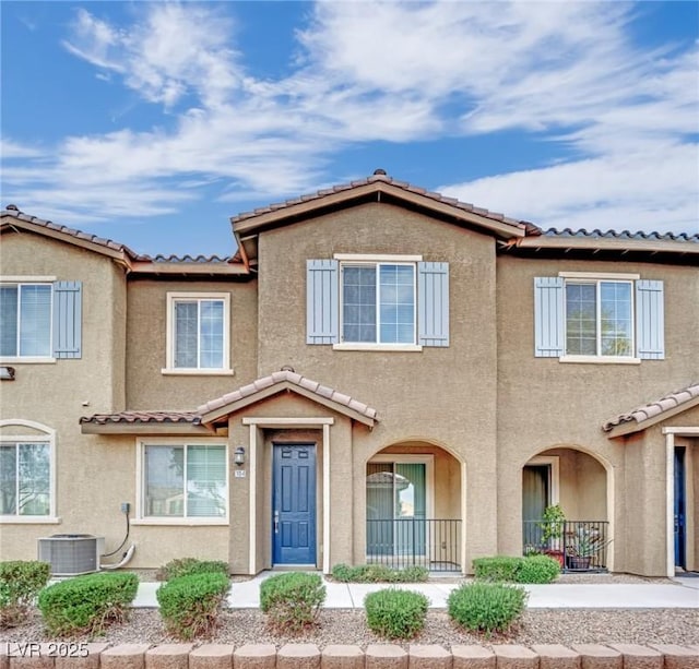 view of property featuring central AC unit and stucco siding