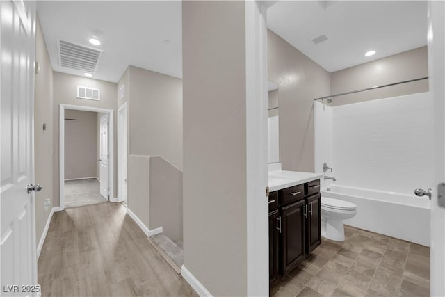 full bath with toilet, vanity, visible vents, and bathing tub / shower combination