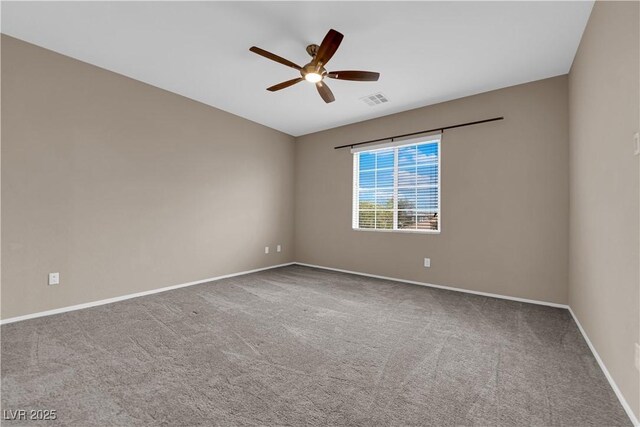 spare room featuring a ceiling fan, visible vents, carpet floors, and baseboards