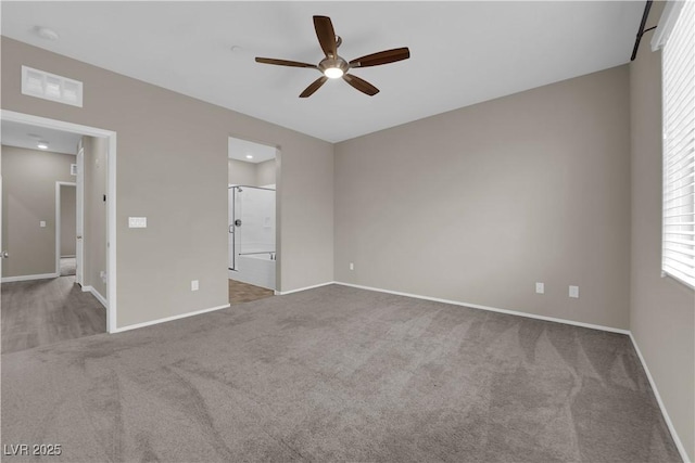 unfurnished bedroom with visible vents, baseboards, a ceiling fan, connected bathroom, and carpet flooring