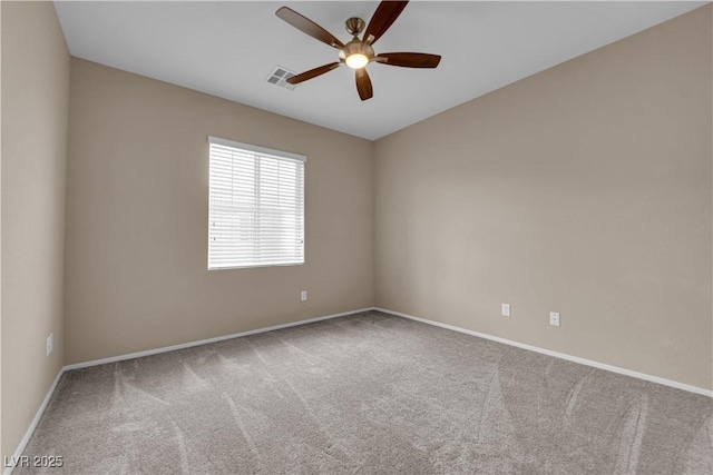 empty room featuring baseboards, visible vents, a ceiling fan, lofted ceiling, and carpet floors