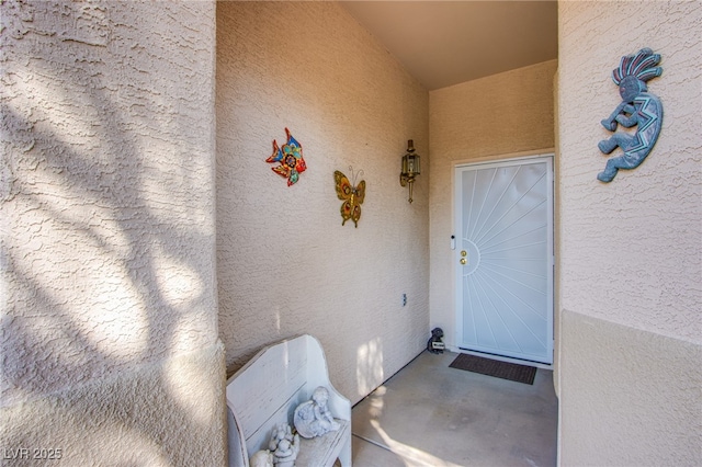 property entrance with stucco siding