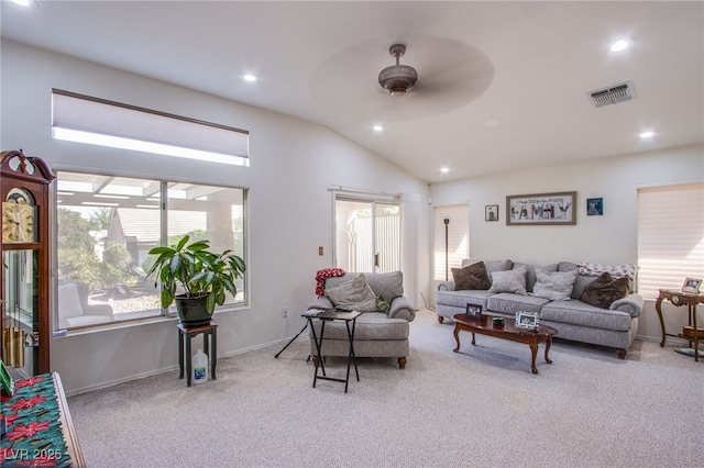 living room with a healthy amount of sunlight, visible vents, ceiling fan, and carpet flooring