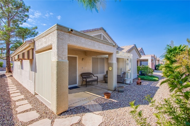 exterior space featuring a patio and stucco siding