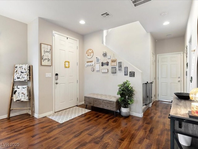 foyer featuring wood finished floors, visible vents, and baseboards