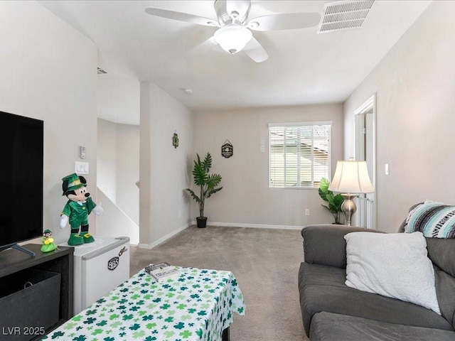 living room featuring light colored carpet, visible vents, ceiling fan, and baseboards