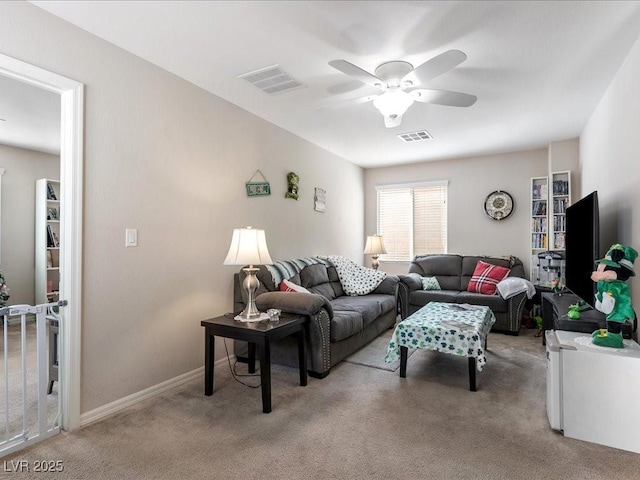 living area with light carpet, ceiling fan, visible vents, and baseboards