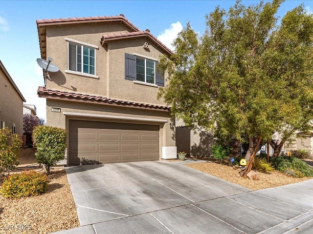 view of front of house with an attached garage, driveway, a tile roof, and stucco siding