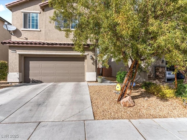 view of front of house featuring a garage, concrete driveway, a tiled roof, and stucco siding