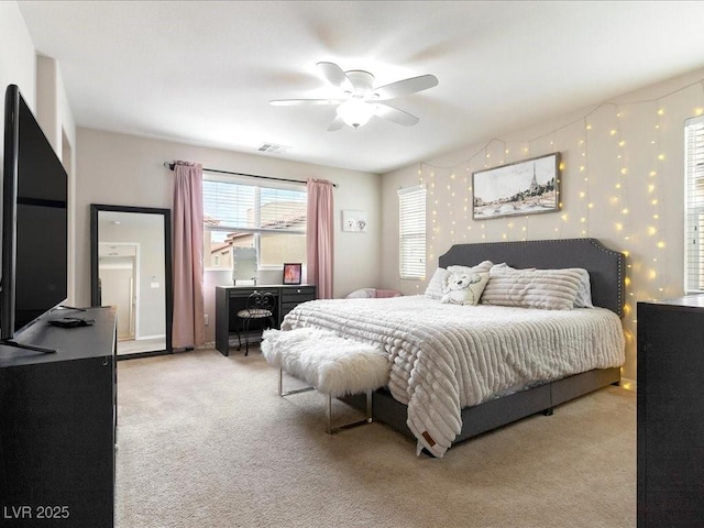 bedroom with light carpet, wallpapered walls, visible vents, and a ceiling fan