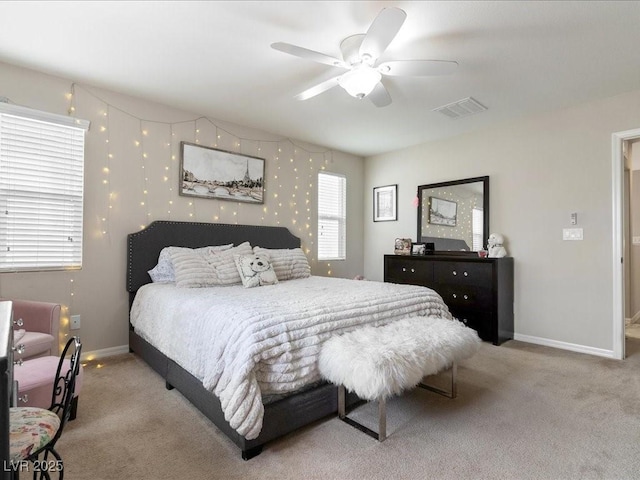 bedroom with baseboards, a ceiling fan, visible vents, and light colored carpet