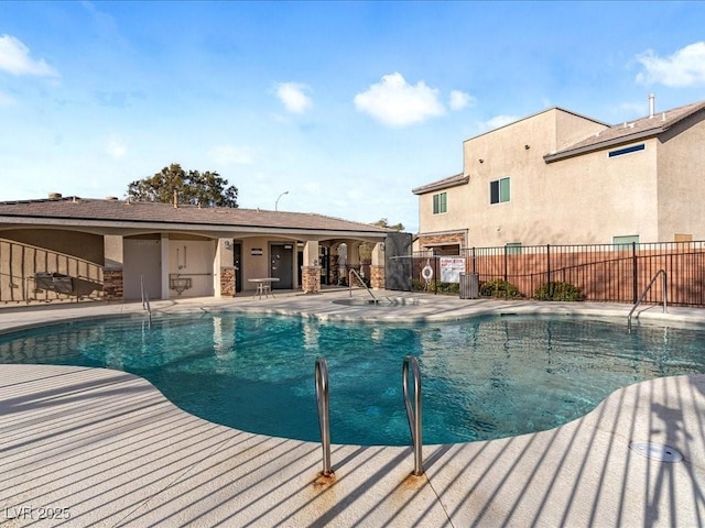 pool featuring central AC unit, a patio area, and fence