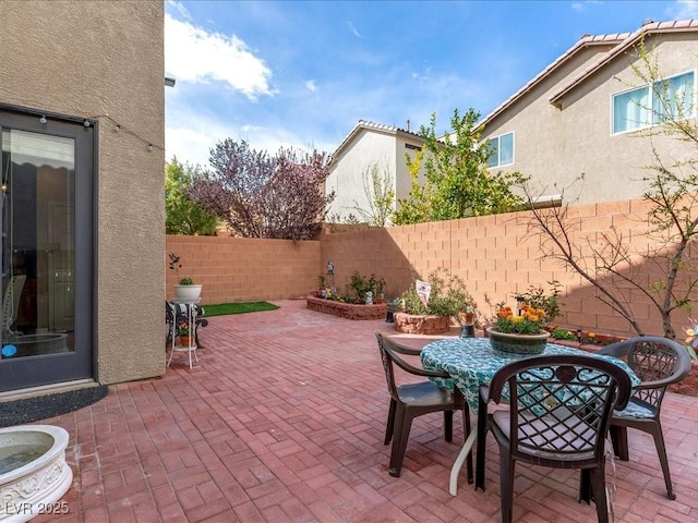 view of patio / terrace featuring outdoor dining space and a fenced backyard