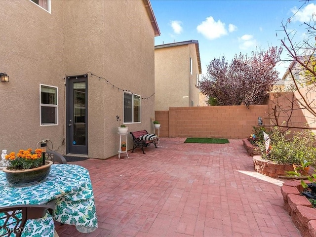 view of patio / terrace featuring fence