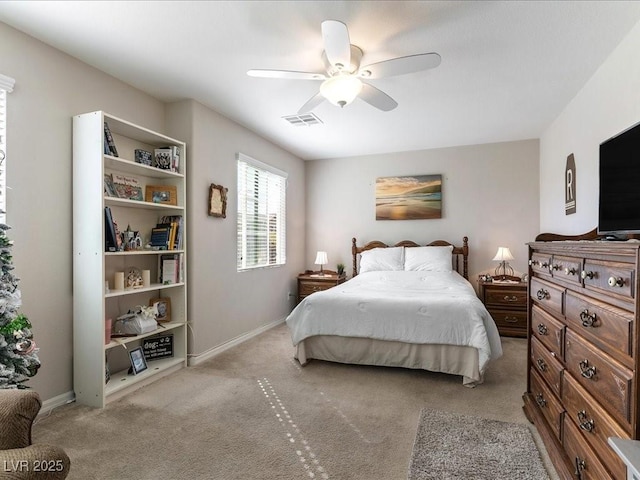 bedroom with baseboards, visible vents, a ceiling fan, and light colored carpet