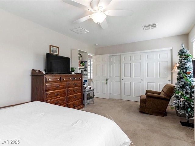 bedroom with ceiling fan, visible vents, a closet, and light colored carpet