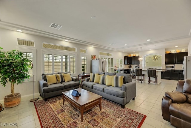 living area featuring light tile patterned floors, baseboards, visible vents, and recessed lighting