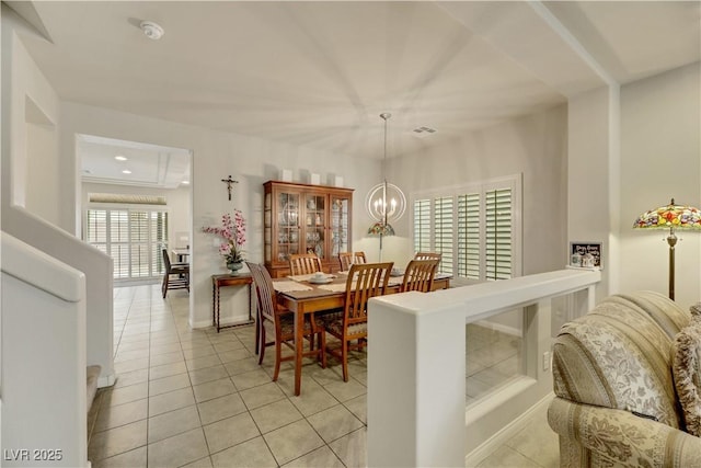 dining space featuring light tile patterned floors, visible vents, and a chandelier