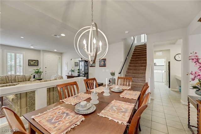 dining area featuring light tile patterned floors, recessed lighting, a notable chandelier, visible vents, and stairway