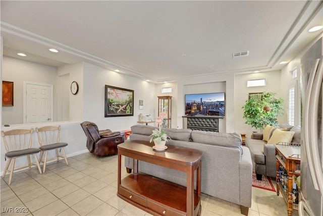 living area featuring light tile patterned flooring, visible vents, and recessed lighting