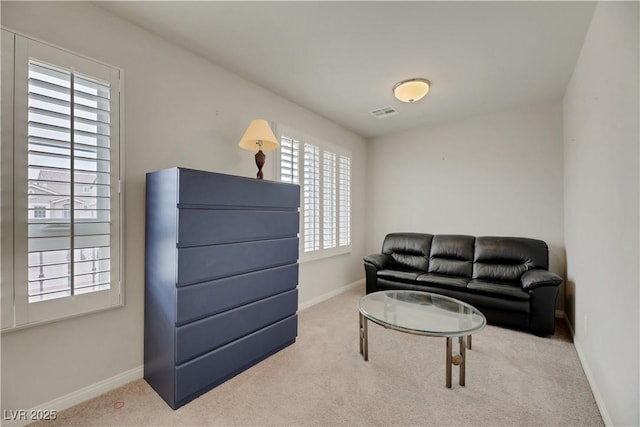 living room featuring carpet floors, visible vents, and baseboards