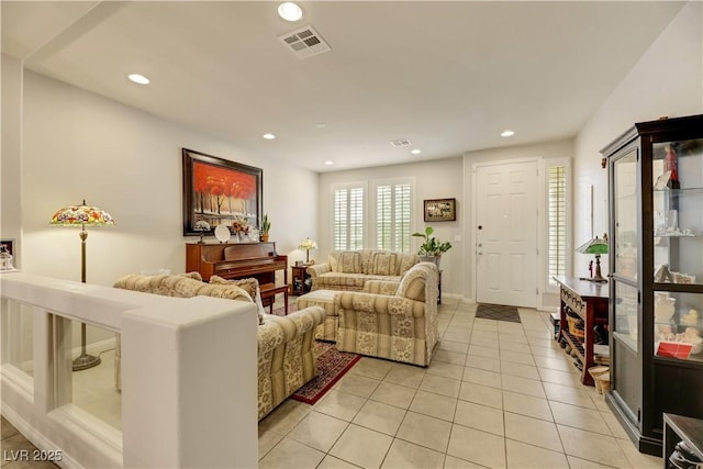 living room featuring light tile patterned floors, visible vents, and recessed lighting