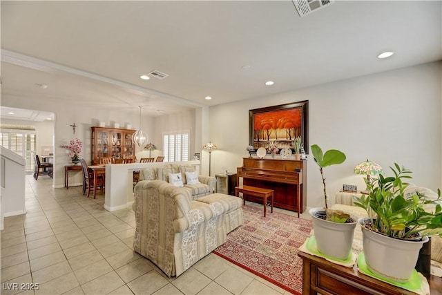 living area with light tile patterned floors, baseboards, visible vents, and recessed lighting