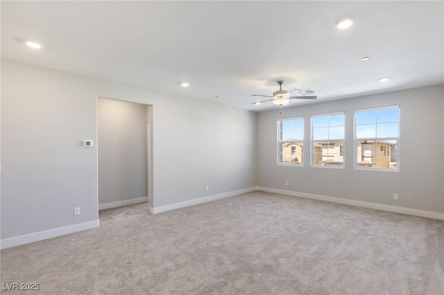 empty room featuring ceiling fan, baseboards, light colored carpet, and recessed lighting