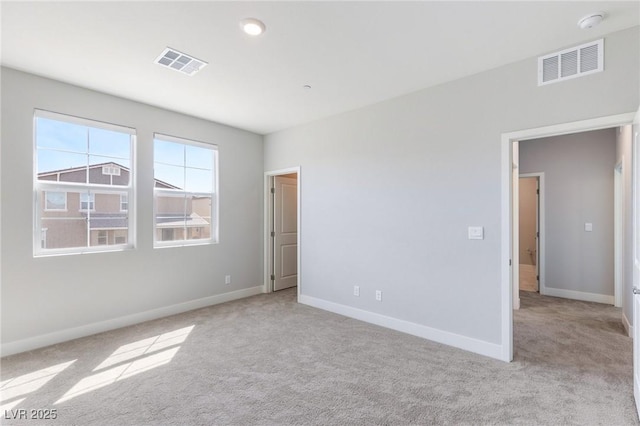 unfurnished bedroom with carpet, visible vents, and baseboards
