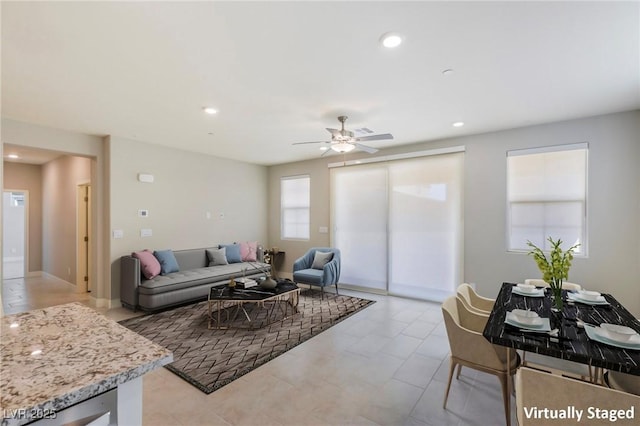 living area with a ceiling fan and recessed lighting