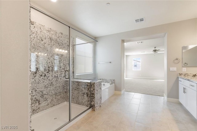 full bathroom featuring ceiling fan, a garden tub, visible vents, vanity, and a stall shower
