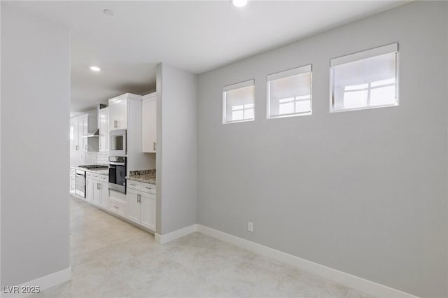 interior space featuring recessed lighting, plenty of natural light, and baseboards