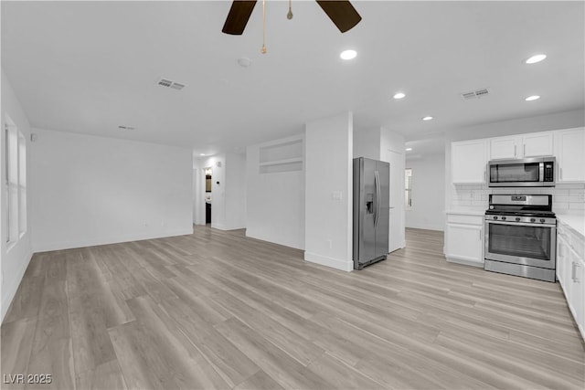 unfurnished living room featuring light wood-style floors, recessed lighting, and visible vents