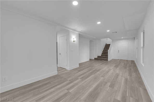 basement featuring recessed lighting, visible vents, baseboards, stairway, and light wood finished floors