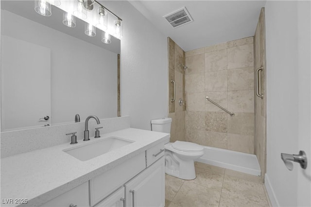 bathroom featuring toilet, vanity, visible vents, tile patterned floors, and a stall shower