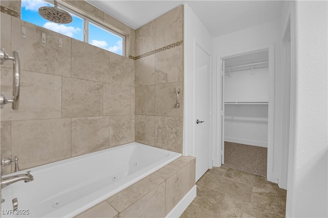 full bath with a combined bath / shower with jetted tub and a walk in closet