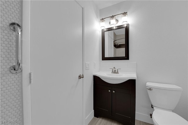 bathroom featuring toilet and vanity